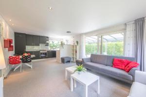a living room with a couch and a table at Jonkerstee 21 - Ouddorp in Ouddorp