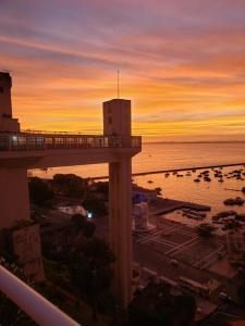a view of a sunset from the balcony of a resort at Apartamento no centro do Rio Vermelho-Ondina in Salvador
