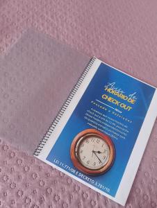 un libro con un orologio sopra di Pousada Solluar a Paracatu