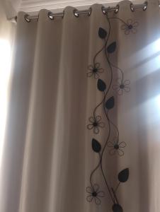 una tenda da doccia con un disegno floreale di Pousada Solluar a Paracatu