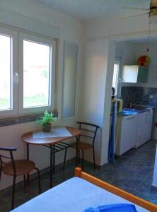 a kitchen with a table and chairs in a room at Villa Abelia in Medulin