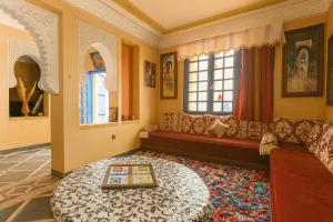 a living room with a couch and a table at arganier solitaire in Souira Guedima