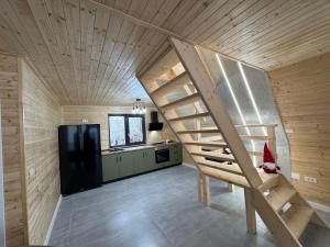 a large room with a staircase in a house at Joy Chalet in Plaiu