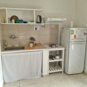 a small kitchen with a sink and a refrigerator at Kalma in Villa Elisa