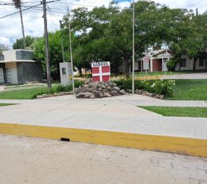 a stop sign sitting on the side of a street at Kalma in Villa Elisa