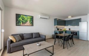 a living room with a couch and a table at Beautiful Apartment In Dingac With Swimming Pool in Gornji Dingač