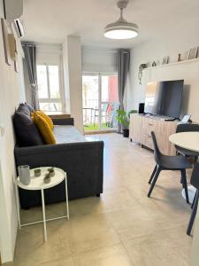 a living room with a couch and a table at Minerva 211 - 24h reception - 1 bedroom in Benalmádena