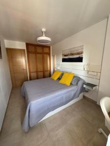 a bedroom with a large bed with two yellow pillows at Minerva 211 - 24h reception - 1 bedroom in Benalmádena +11 photos