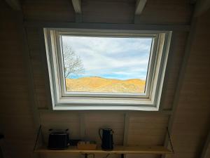 a window in a bathroom with a view of a mountain at TOURMALYS Chalet in Campan