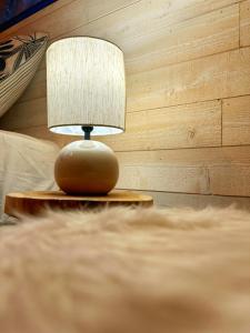 a lamp sitting on a table next to a bed at TOURMALYS Chalet in Campan +23 photos