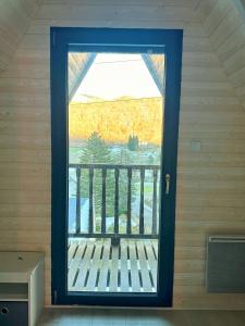 a window in a room with a bench in front of it at TOURMALYS Chalet in Campan