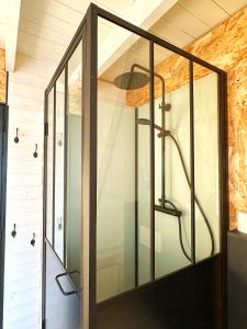 a glass shower in a room with a ceiling at TOURMALYS Chalet in Campan