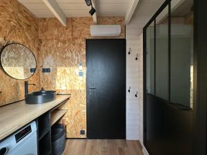 a kitchen with a black door and a sink at TOURMALYS Chalet in Campan