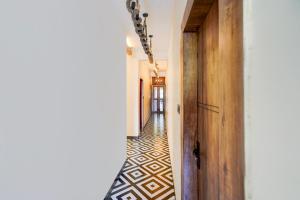 a hallway with a tile floor and a door at Collection O Baga Beach Goa Formerly Traveller Guest House in Baga