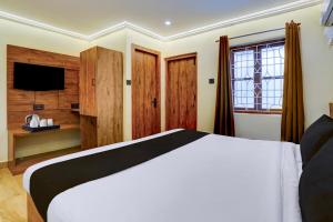 Ένα ή περισσότερα κρεβάτια σε δωμάτιο στο Collection O Baga Beach Goa Formerly Traveller Guest House