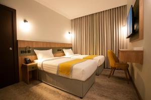 a hotel room with a bed and a desk at HDN Hotel فندق هدن in Mecca