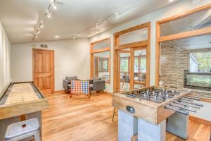 a living room with two foosball tables at Ski House 217 in Bend