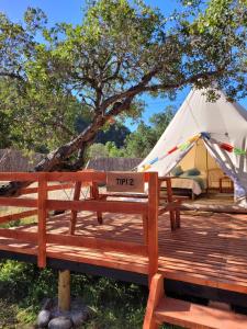 un cartello su una panca di legno davanti a una tenda di Achibueno Glamping a Linares