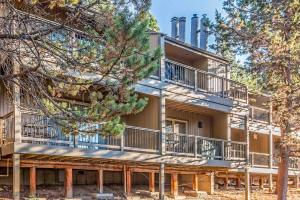 a building with balconies and trees in front of it at Ski House 217 in Bend