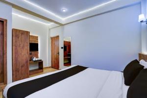 Ένα ή περισσότερα κρεβάτια σε δωμάτιο στο Collection O Baga Beach Goa Formerly Traveller Guest House