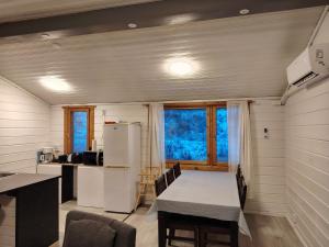a kitchen with a table and a refrigerator at Lomariihi 6 in Muurame