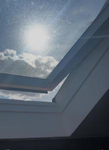 a window in the roof of a house with the sky at Logement atypique in Asnières-sur-Seine +5 photos