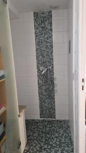 een badkamer met een douche en een tegelvloer bij La suite d'Ananda in Villefranche-de-Rouergue