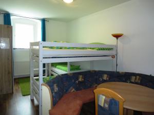 a room with two bunk beds and a couch at Rentcenter79 in Vordernberg