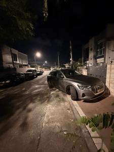 a car parked on the side of a street at night at SeaSide Villa in Ashdod +2 photos