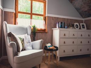 a living room with a chair and a dresser at Large holiday villa with sauna, jacuzzi and pool in Perlino