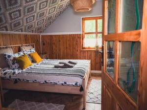a bedroom with a bed with yellow and blue pillows at Large holiday villa with sauna, jacuzzi and pool in Perlino +41 photos