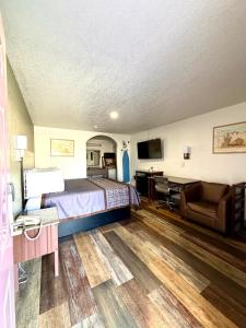 a hotel room with a bed and a desk at Kermit Inn in Kermit