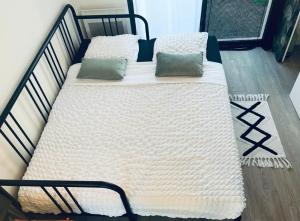 two beds with pillows sitting on top of each other at Studio du port avec jardin privé in Saint-André-de-Cubzac