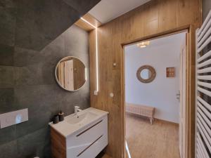 een badkamer met een wastafel en een spiegel bij Apartament 7niebo in Gliczarów Górny +19 foto's