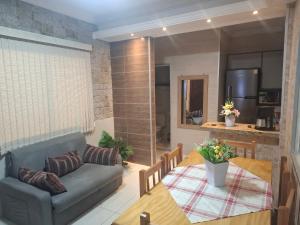 a living room with a couch and a table at Casa 2 Encanto dos Mares in Itapema