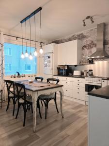 a kitchen with a table and chairs in a room at Arctic Circle Home in Rovaniemi