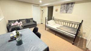 a living room with a couch and a bed at Sabrina's Home in Delta