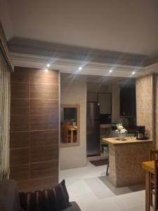 a kitchen with wooden walls and a kitchen with a refrigerator at Casa 2 Encanto dos Mares in Itapema +18 photos