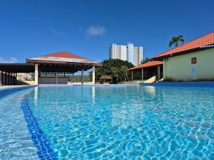a swimming pool with blue water in a building at Sea Breeze Villa in Fajardo