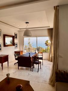 a living room with a pool table and a large window at Adagio House - Best View - Marsa Gammarth Sup in La Marsa