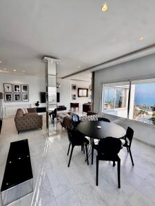 a large living room with a table and chairs at Adagio House - Best View - Marsa Gammarth Sup in La Marsa