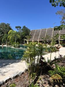 a resort with a pool in front of a building at Peregrina Tulum 301C 1BR Condo in Tulum