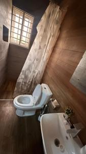 a bathroom with a toilet and a sink at Private Home with Access to Beach Front -Krokrobite in Kokrobite