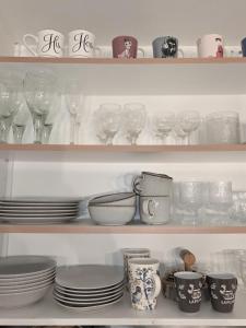 a shelf filled with dishes and glasses and plates at Arctic Circle Home in Rovaniemi +10 photos
