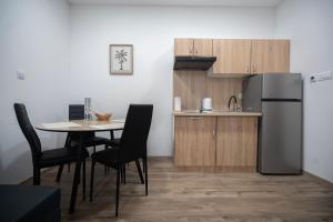 a kitchen with a table and a stainless steel refrigerator at Studio apartman MALA OAZA in Kistanje +7 photos