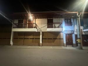 a building with two balconies and a gate at night at Hotel Jardin de Rosas in Jardin +67 photos