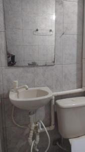 a bathroom with a sink and a toilet at Paradise Hostel Recife Sul in Recife