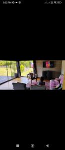 a view of a living room with a couch and a tv at Casa Palguin in Minetué