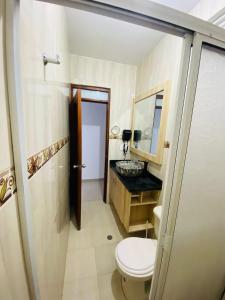 a bathroom with a toilet and a sink at Hotel Piedra Mágica in Capurganá