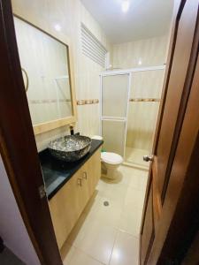 a bathroom with a sink and a toilet at Hotel Piedra Mágica in Capurganá